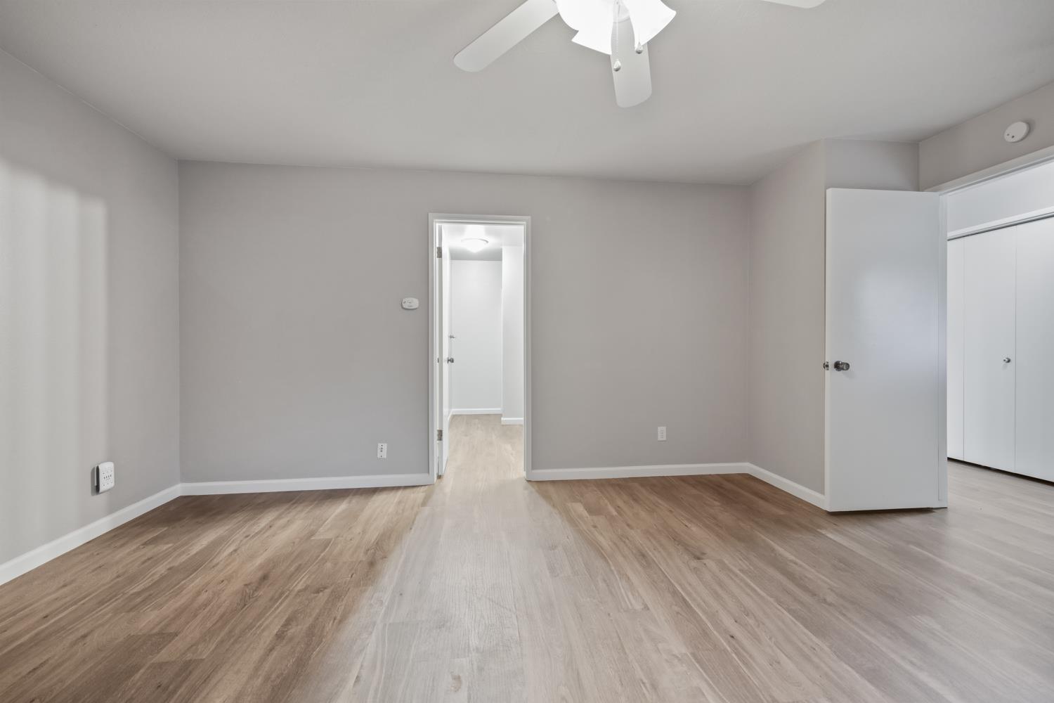 1001 West Lincoln Road, Unit A Stockton, CA 95207 - Photo 13 of 32 a view of an empty room with wooden floor