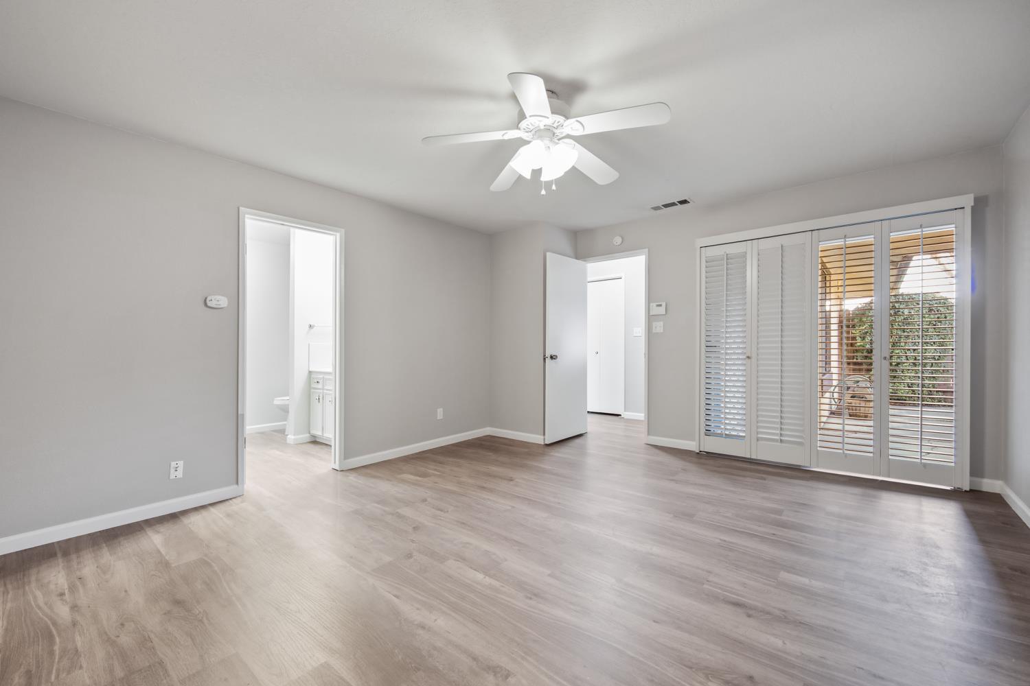 1001 West Lincoln Road, Unit A Stockton, CA 95207 - Photo 16 of 32 an empty room with wooden floor and windows