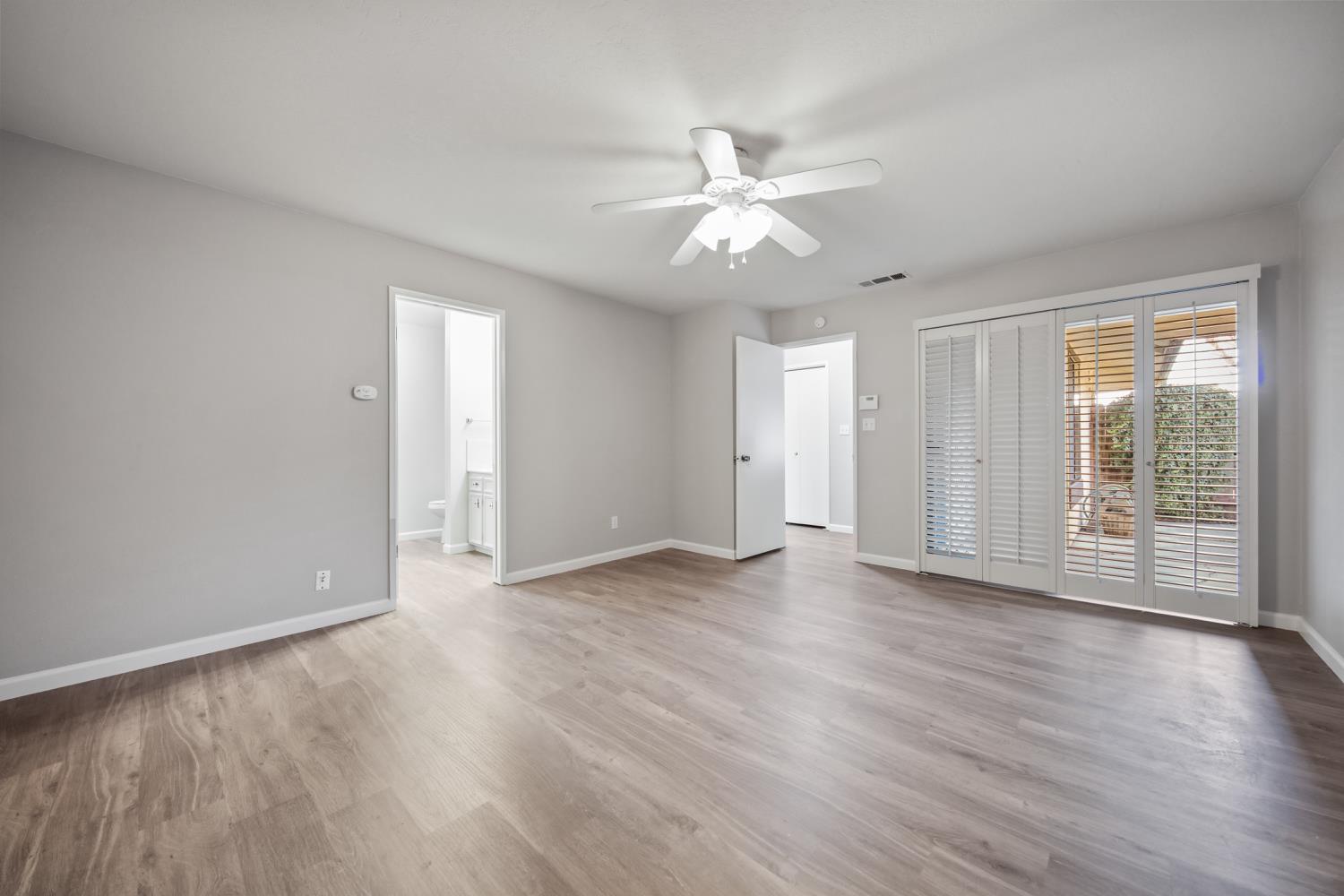 1001 West Lincoln Road, Unit A Stockton, CA 95207 - Photo 17 of 32 an empty room with wooden floor and windows