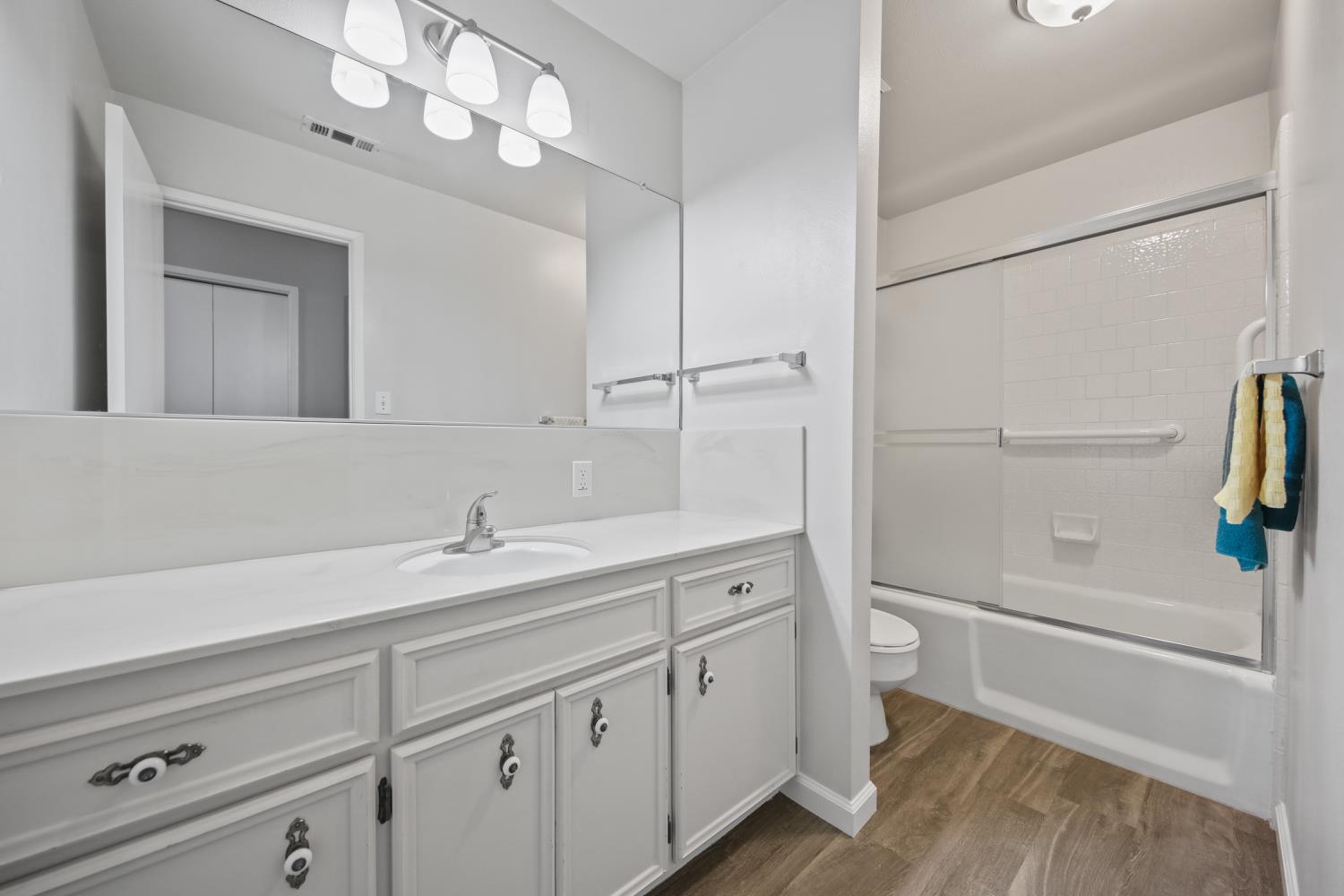 1001 West Lincoln Road, Unit A Stockton, CA 95207 - Photo 20 of 32 a bathroom with a sink a toilet and shower