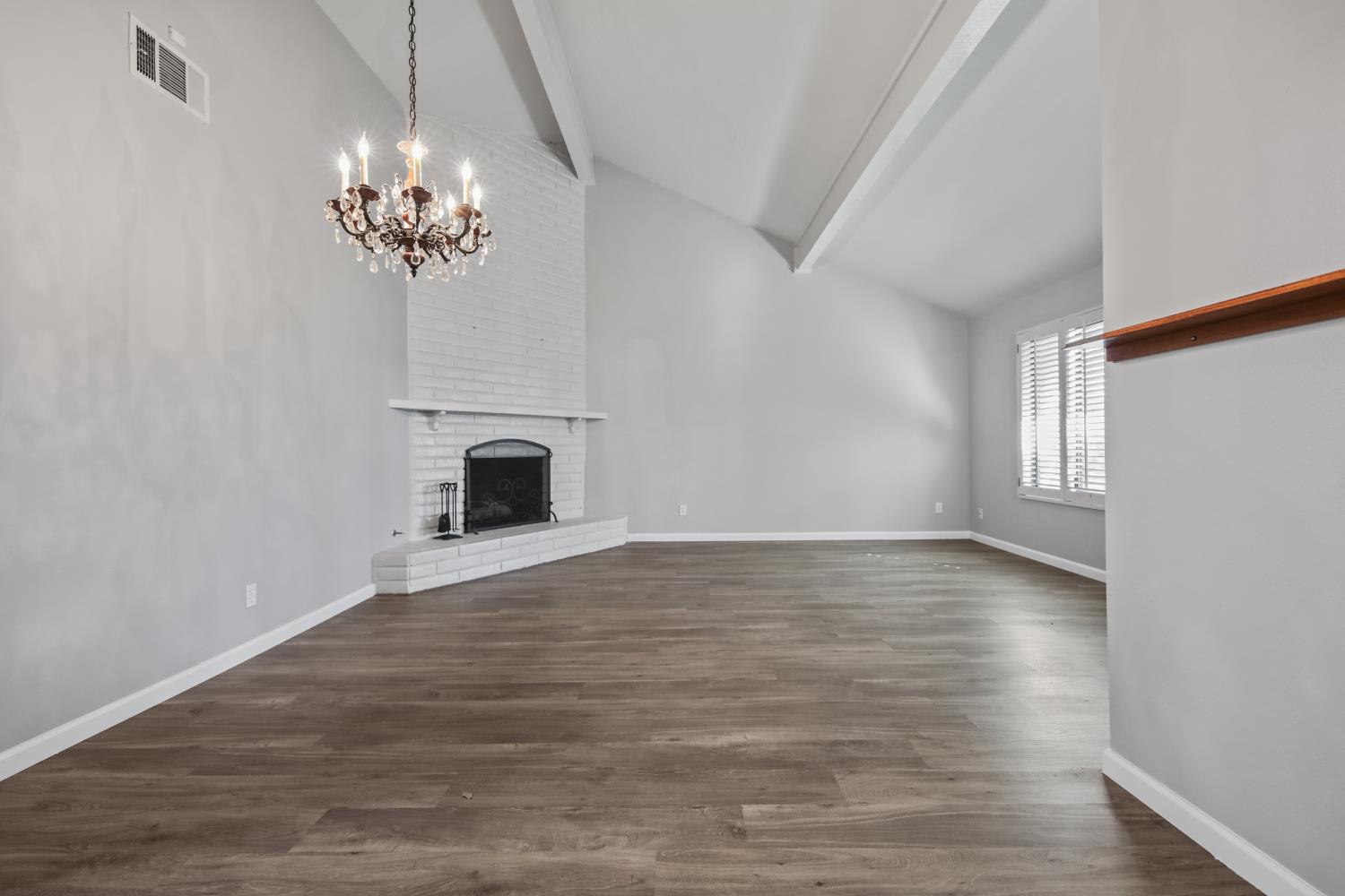1001 West Lincoln Road, Unit A Stockton, CA 95207 - Photo 7 of 32 a view of a room with a fireplace chandelier and wooden floor