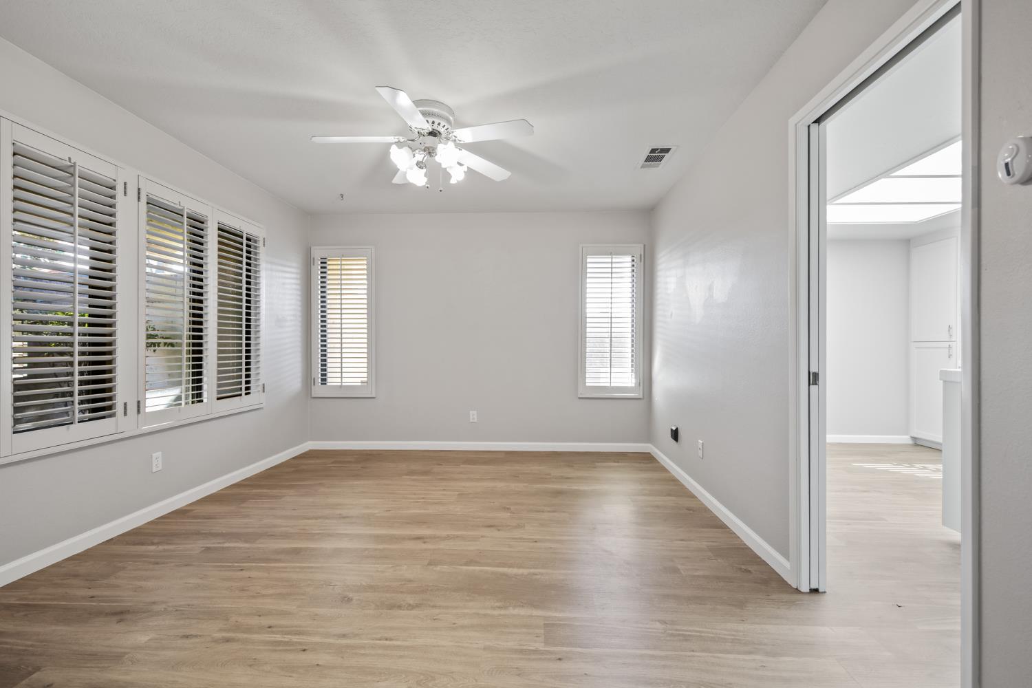 1001 West Lincoln Road, Unit A Stockton, CA 95207 - Photo 9 of 32 a view of an empty room with wooden floor and a window