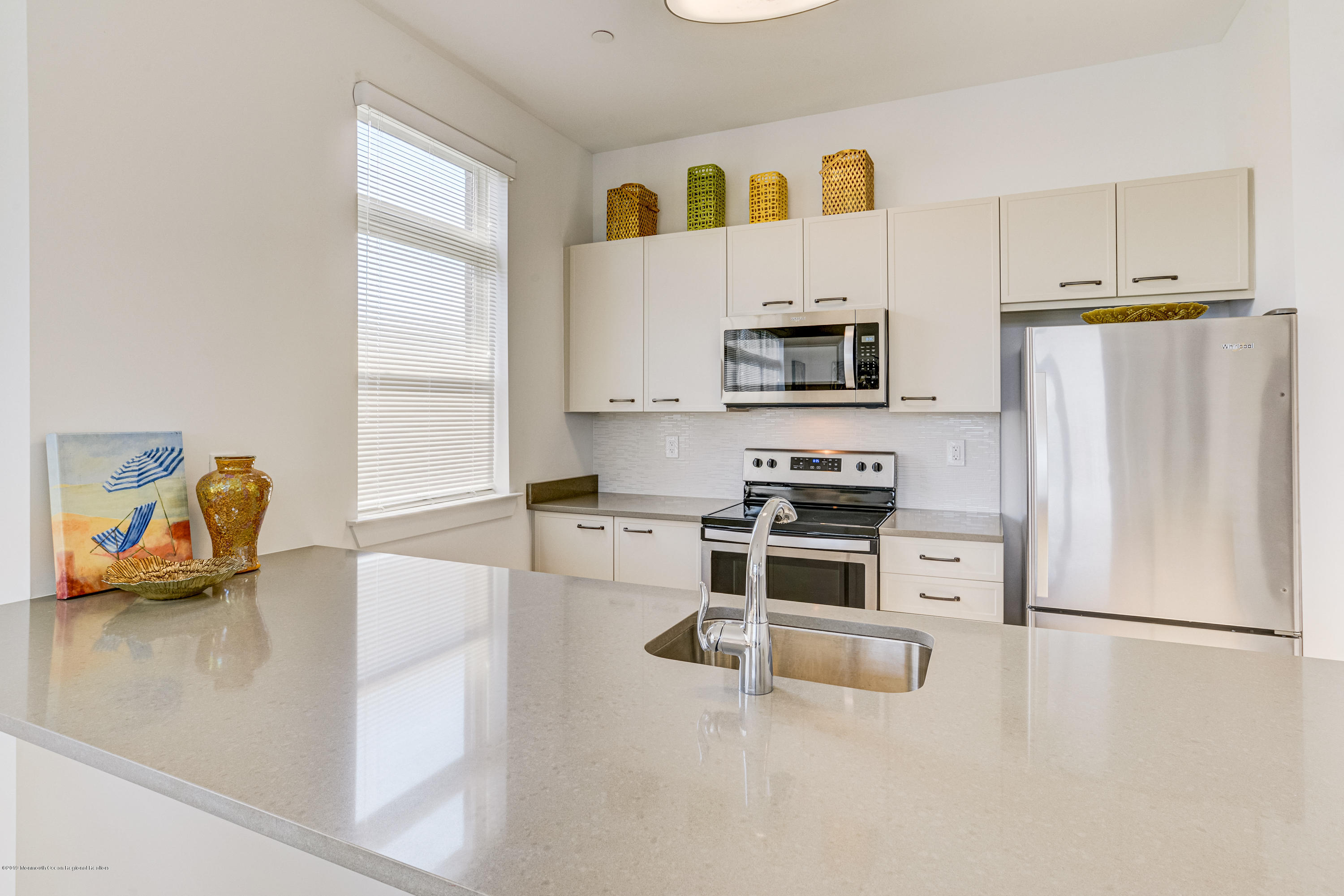 55 West Front Street, Unit 201 Red Bank, NJ 07701 - Photo 11 of 26 a kitchen with stainless steel appliances a refrigerator a stove a sink a microwave and a refrigerator