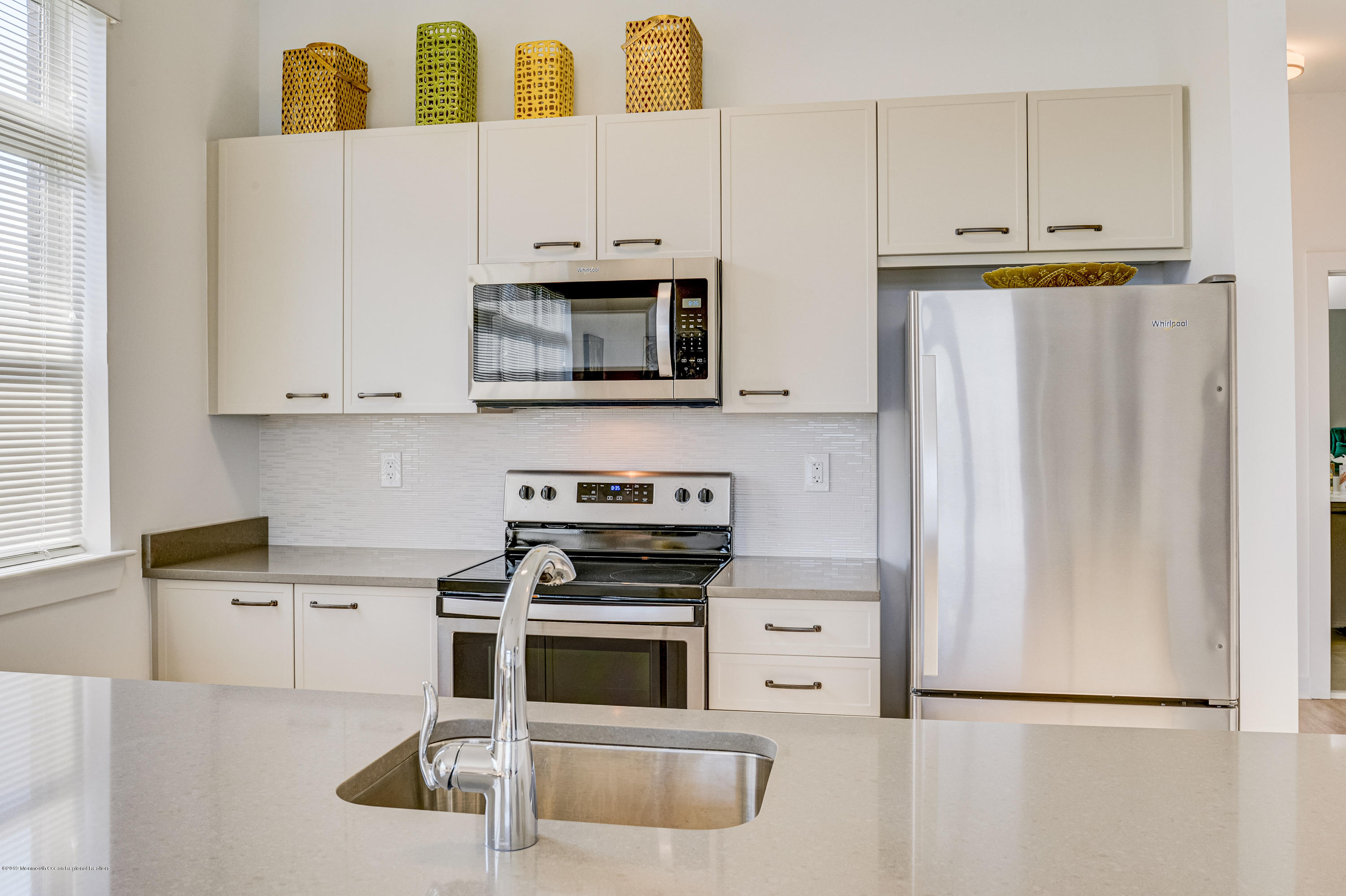 55 West Front Street, Unit 201 Red Bank, NJ 07701 - Photo 12 of 26 a kitchen with stainless steel appliances a stove microwave and refrigerator