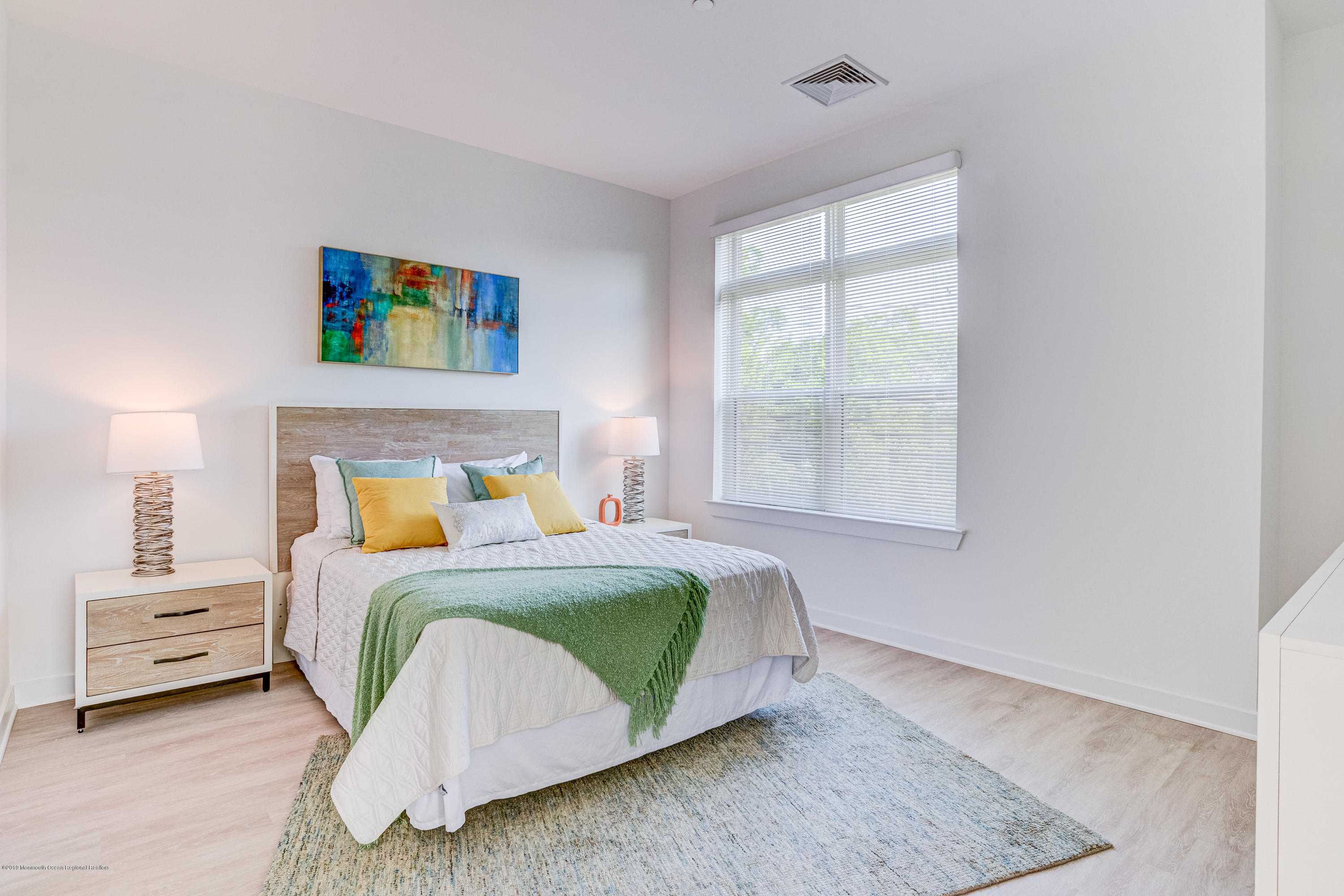 55 West Front Street, Unit 201 Red Bank, NJ 07701 - Photo 13 of 26 a bedroom with a bed and a window