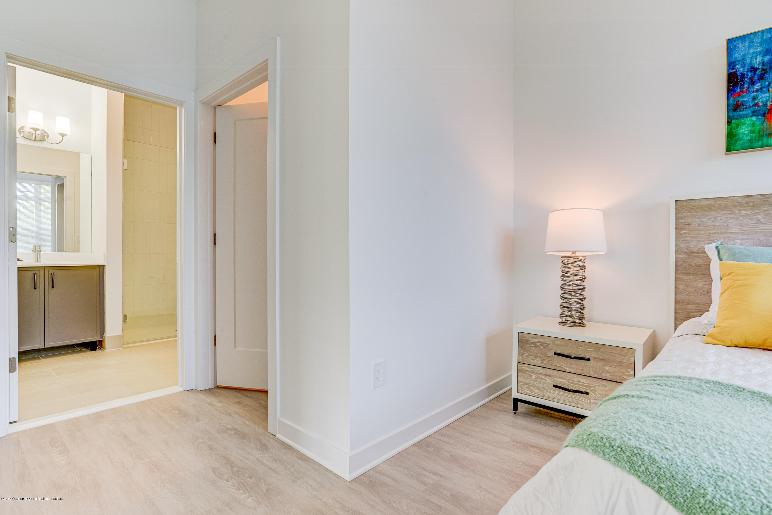 55 West Front Street, Unit 201 Red Bank, NJ 07701 - Photo 16 of 26 a bedroom with a bed and a lamp