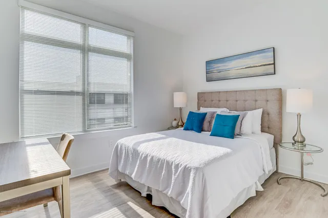 a bedroom with a bed and a window