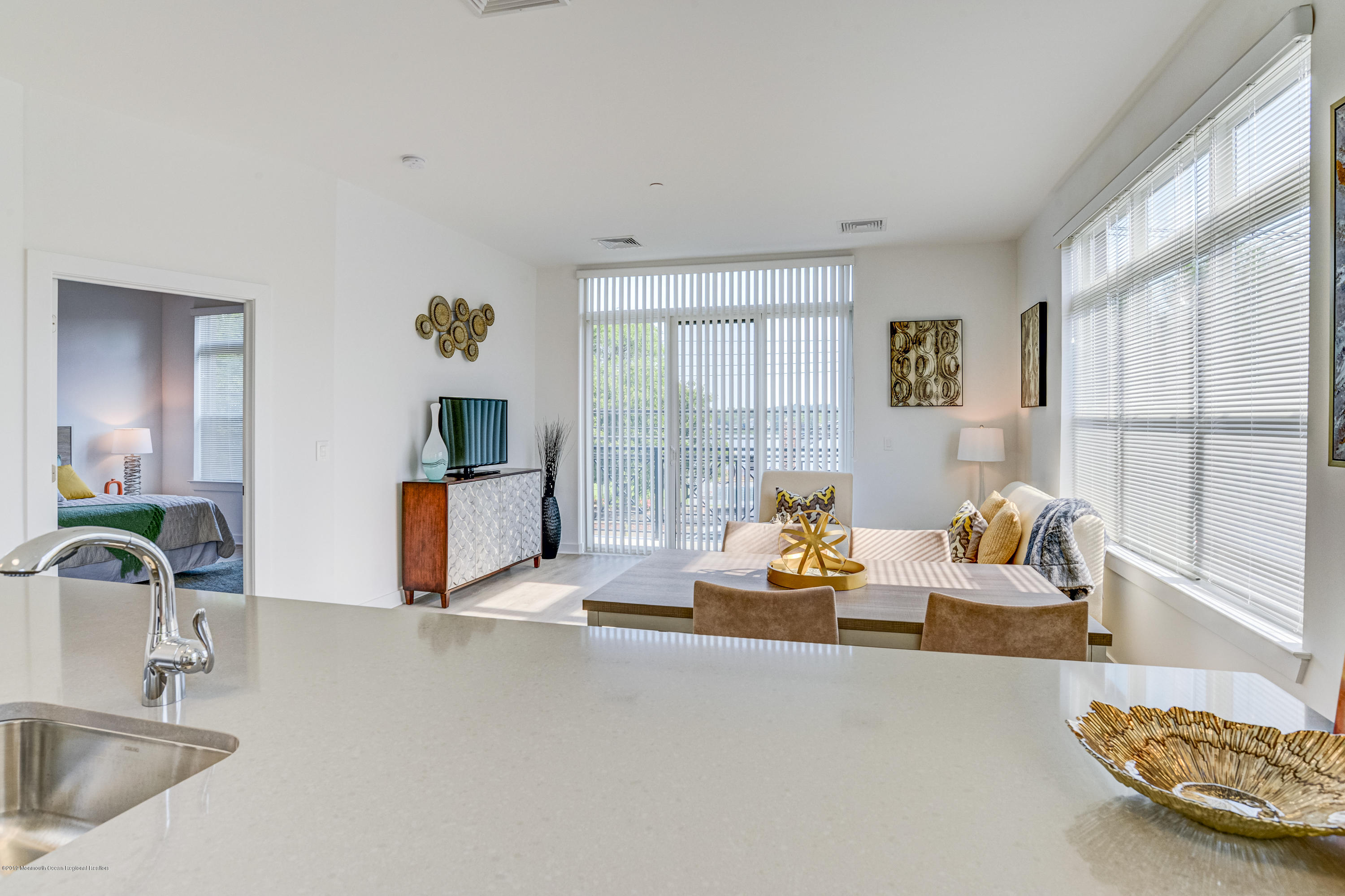 55 West Front Street, Unit 201 Red Bank, NJ 07701 - Photo 6 of 26 a living room with furniture and a large window