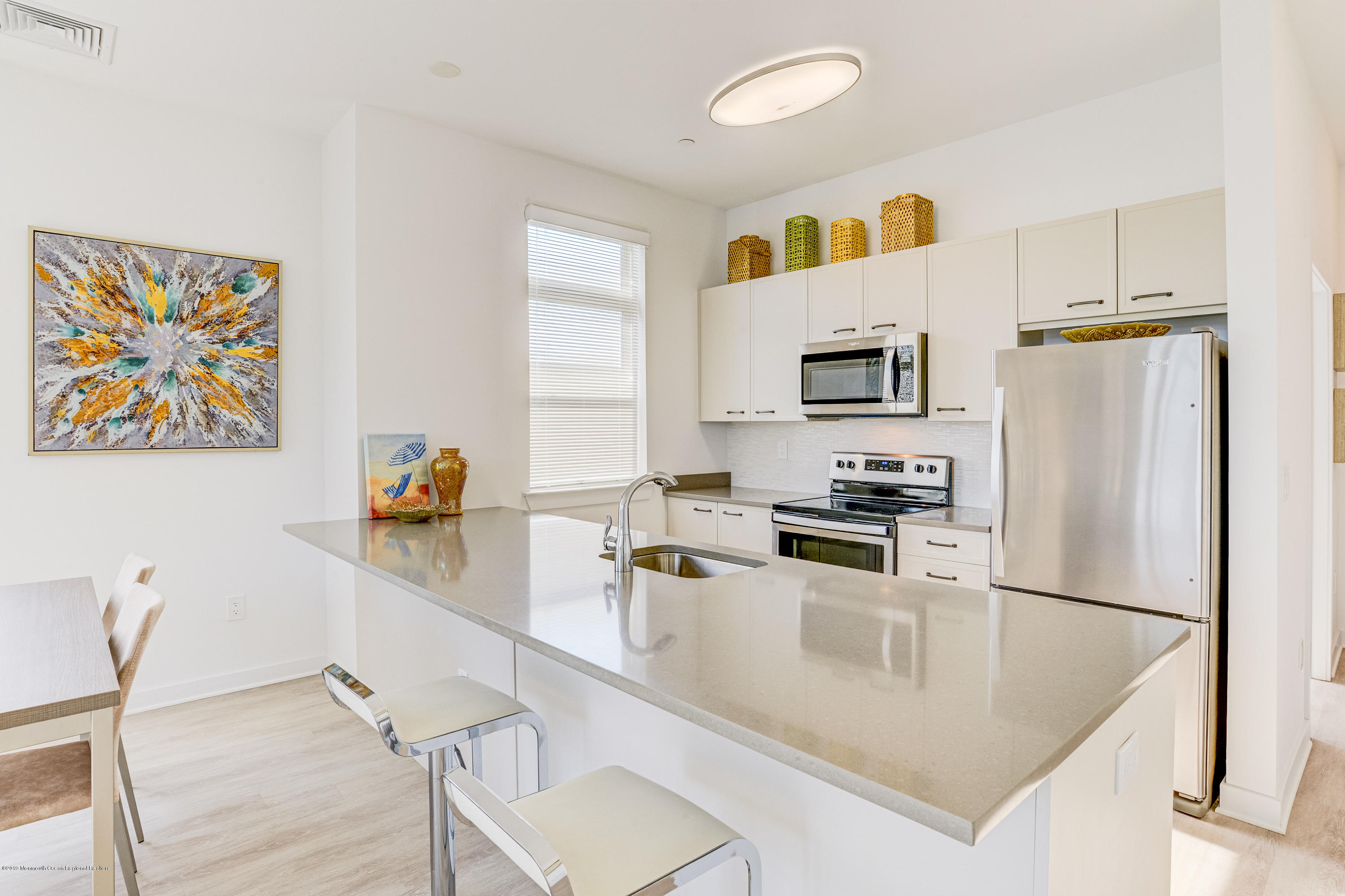 55 West Front Street, Unit 201 Red Bank, NJ 07701 - Photo 10 of 26 a kitchen with a sink a refrigerator and a stove top oven