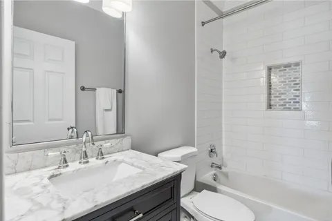 a bathroom with a sink vanity and mirror