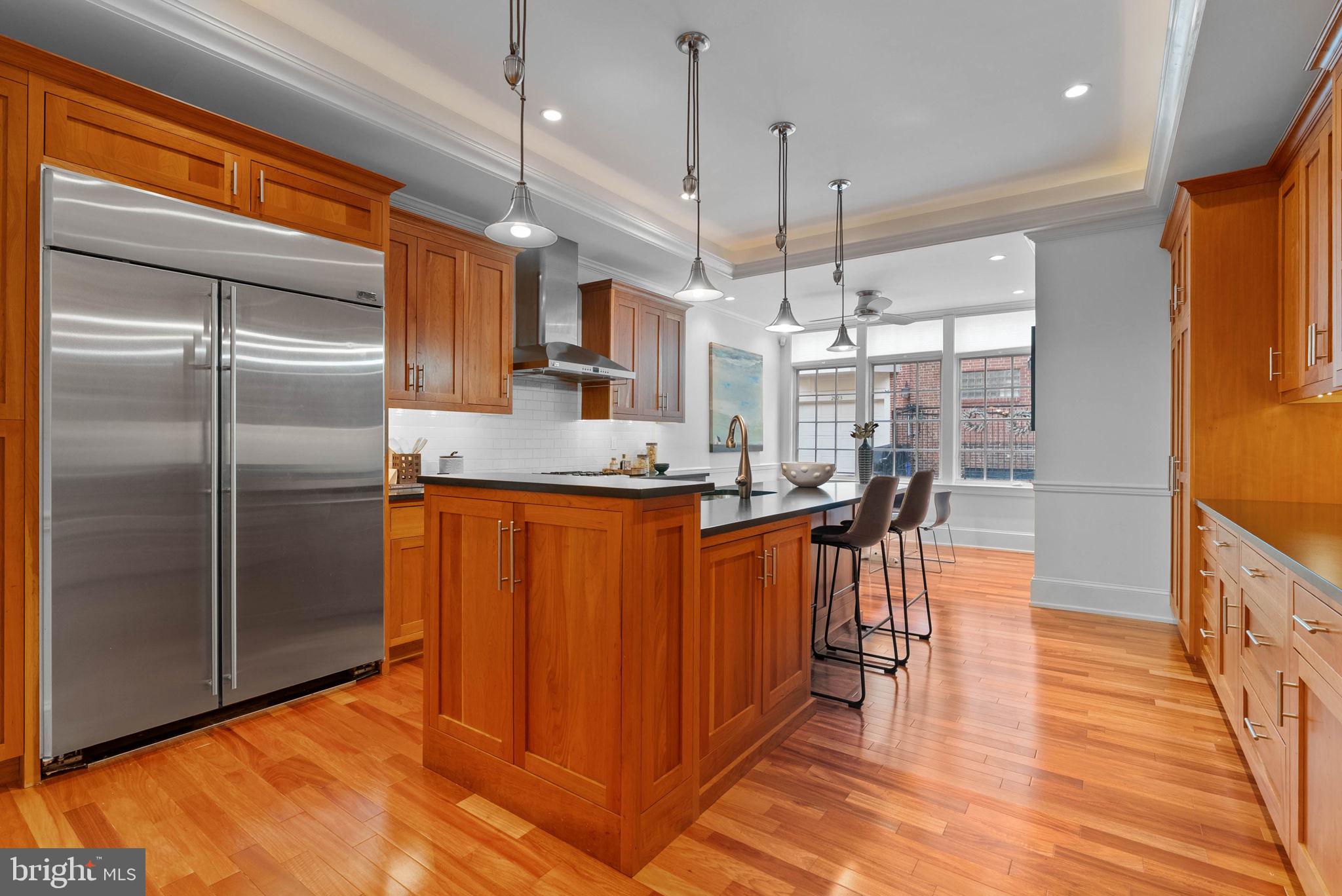 2019 Rittenhouse Square Philadelphia, PA 19103 - Photo 16 of 54 a kitchen with stainless steel appliances granite countertop a refrigerator a oven a sink and a dining table with wooden floor