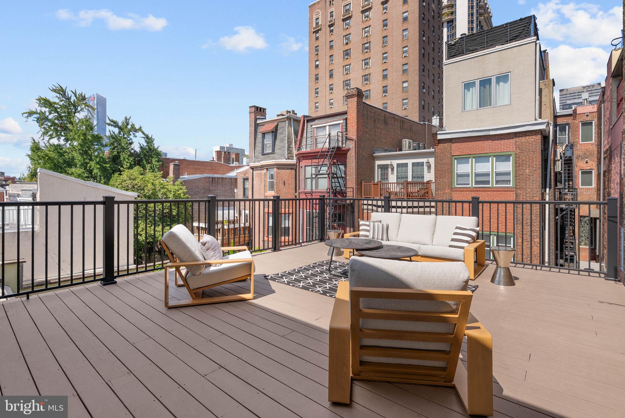 2019 Rittenhouse Square Philadelphia, PA 19103 - Photo 44 of 54 a view of a deck with couches table and chairs and wooden floor