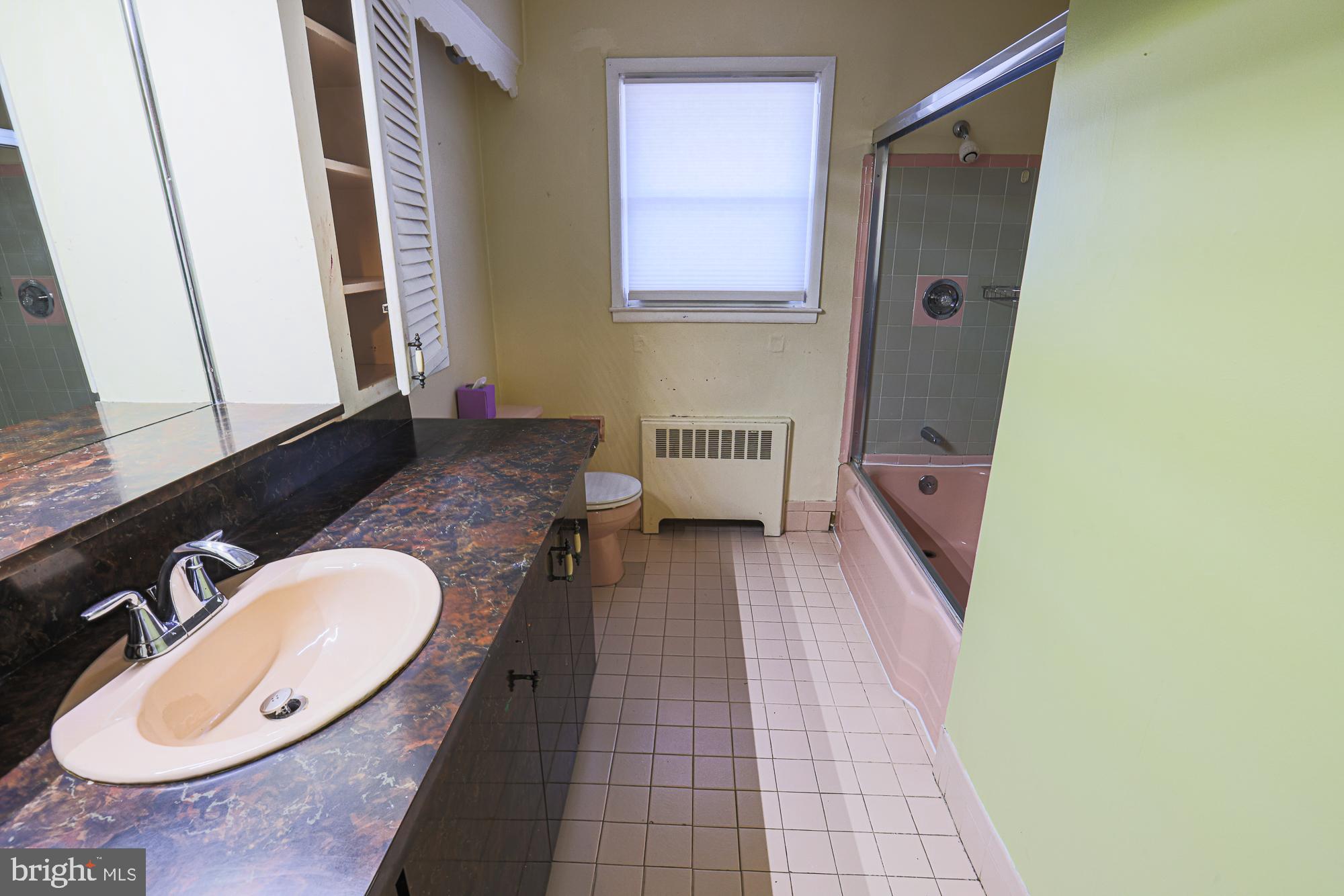 6605 Deancroft Road Baltimore, MD 21209 - Photo 24 of 31 a bathroom with a sink and a mirror
