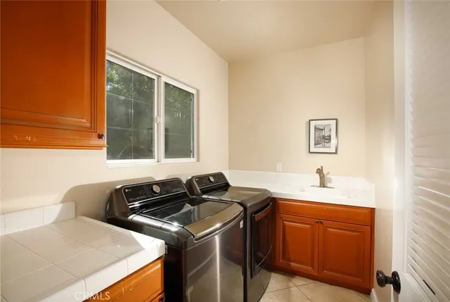 a kitchen with a sink and a stove top oven