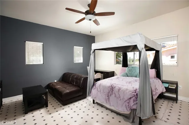 a bedroom with a bed a couch and a dresser