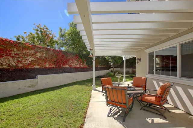a living room with patio furniture and garden
