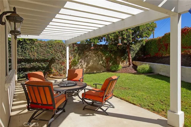 a view of a patio with table and chairs and potted plants