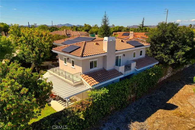 an aerial view of a house with a yard basket ball court and outdoor seating