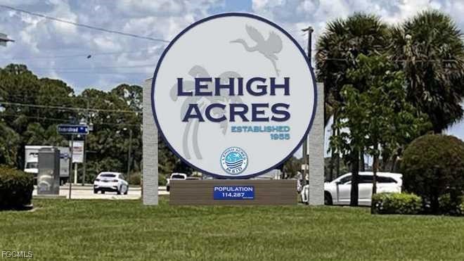 1822 Marson Street Lehigh Acres, FL 33972 - Photo 4 of 4 a sign that is sitting on the side of a building