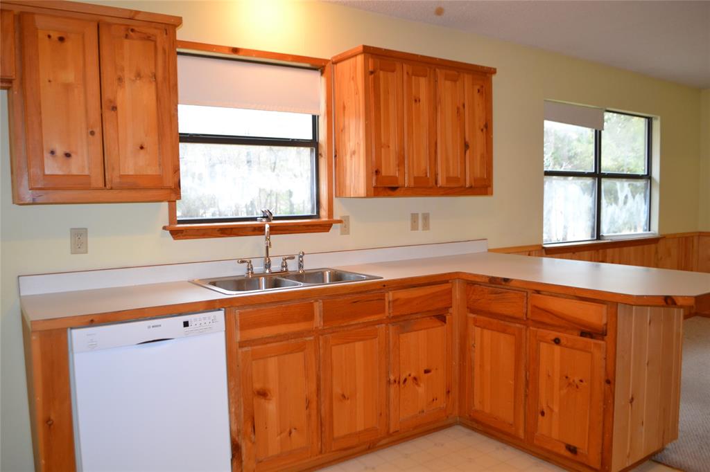 213 County Road 1997 Yantis, TX 75497 - Photo 16 of 28 a kitchen with stainless steel appliances granite countertop a sink and a window