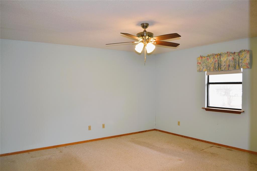 213 County Road 1997 Yantis, TX 75497 - Photo 17 of 28 an empty room with a window and a ceiling fan