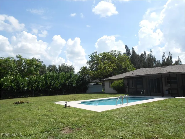 a view of a swimming pool with a yard