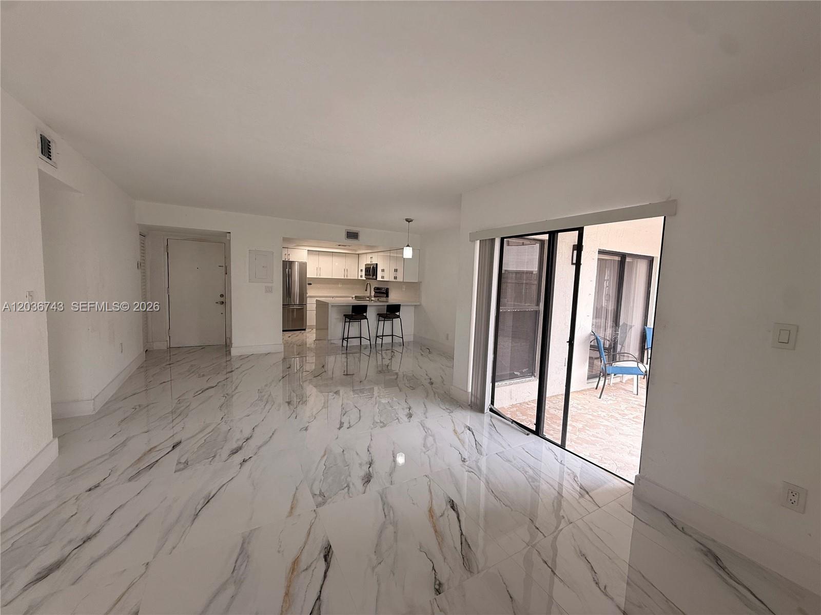 10875 Northwest 7th Street, Unit 1136 Miami, FL 33172 - Photo 7 of 25 an empty room with wooden floor and a window