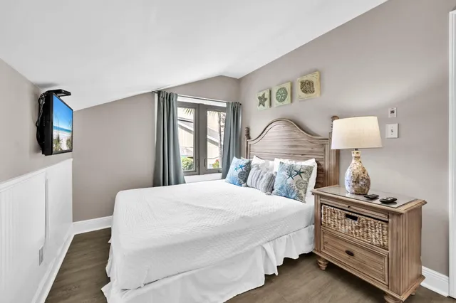 a large bedroom with a large bed and a large window