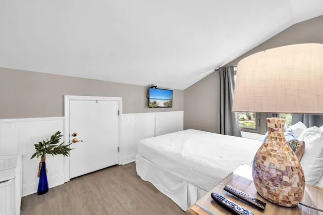 a spacious bedroom with a large bed and a large window