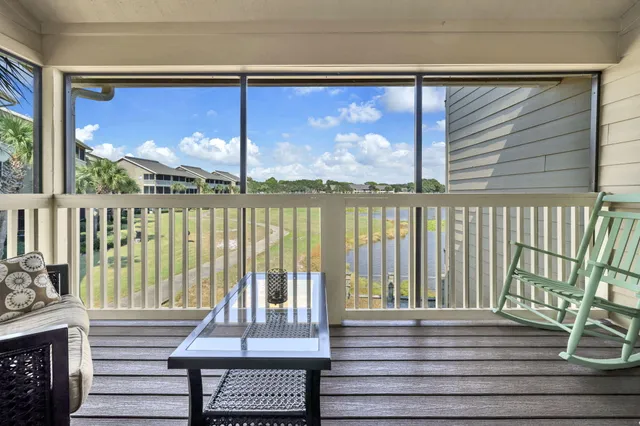a view of a balcony with a floor to ceiling window next to a yard