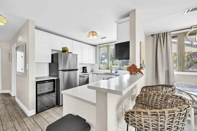 a kitchen with refrigerator and window