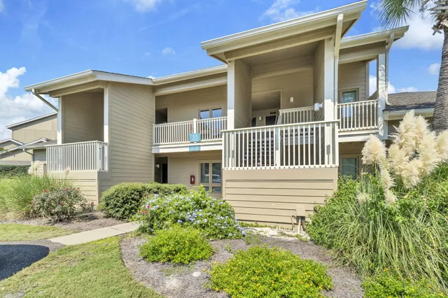 a view of a park with large trees and slides
