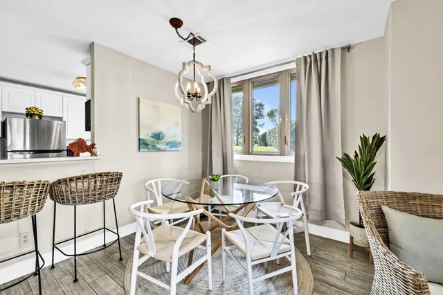 a view of a dining room with furniture window and wooden floor