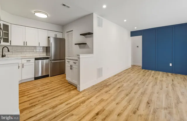 a kitchen with stainless steel appliances a refrigerator and a sink