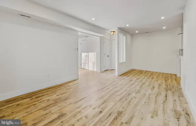 a view of hallway with wooden floor