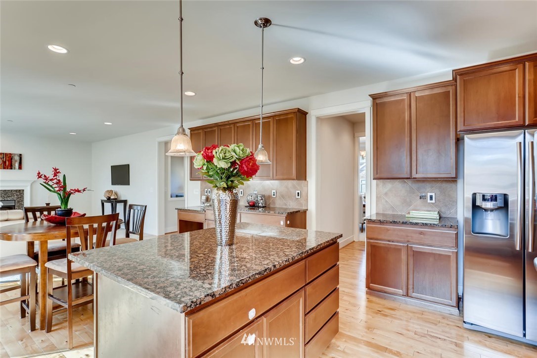 3110 222nd Street Southeast Bothell, WA 98021 - Photo 8 of 23 a kitchen with stainless steel appliances granite countertop a kitchen island a stove and a cabinets