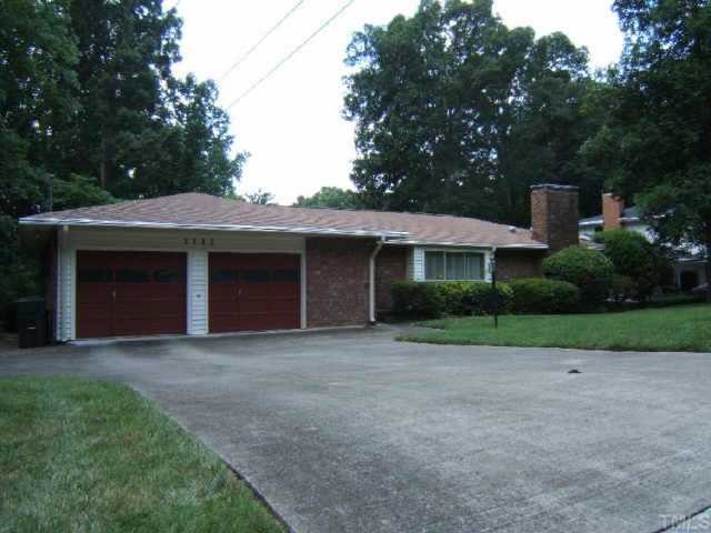 1112 Mayberry Place Raleigh, NC 27609 - Photo 1 of 1 a front view of a house with a garden and yard