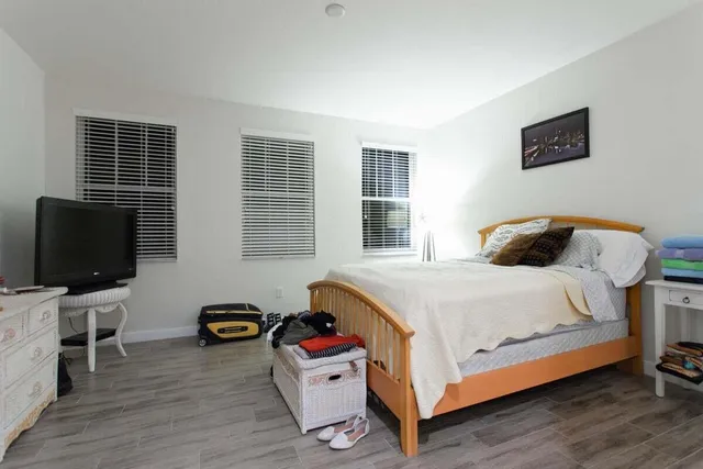 a bedroom with a bed and flat screen tv