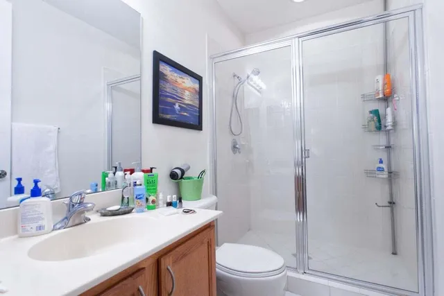 a bathroom with a sink toilet and shower