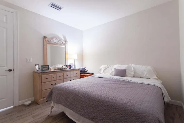 a bedroom with a bed and a dresser