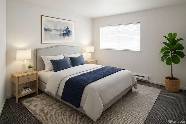 a bedroom with bed and a potted plant