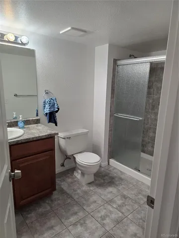 a bathroom with a toilet a sink and shower