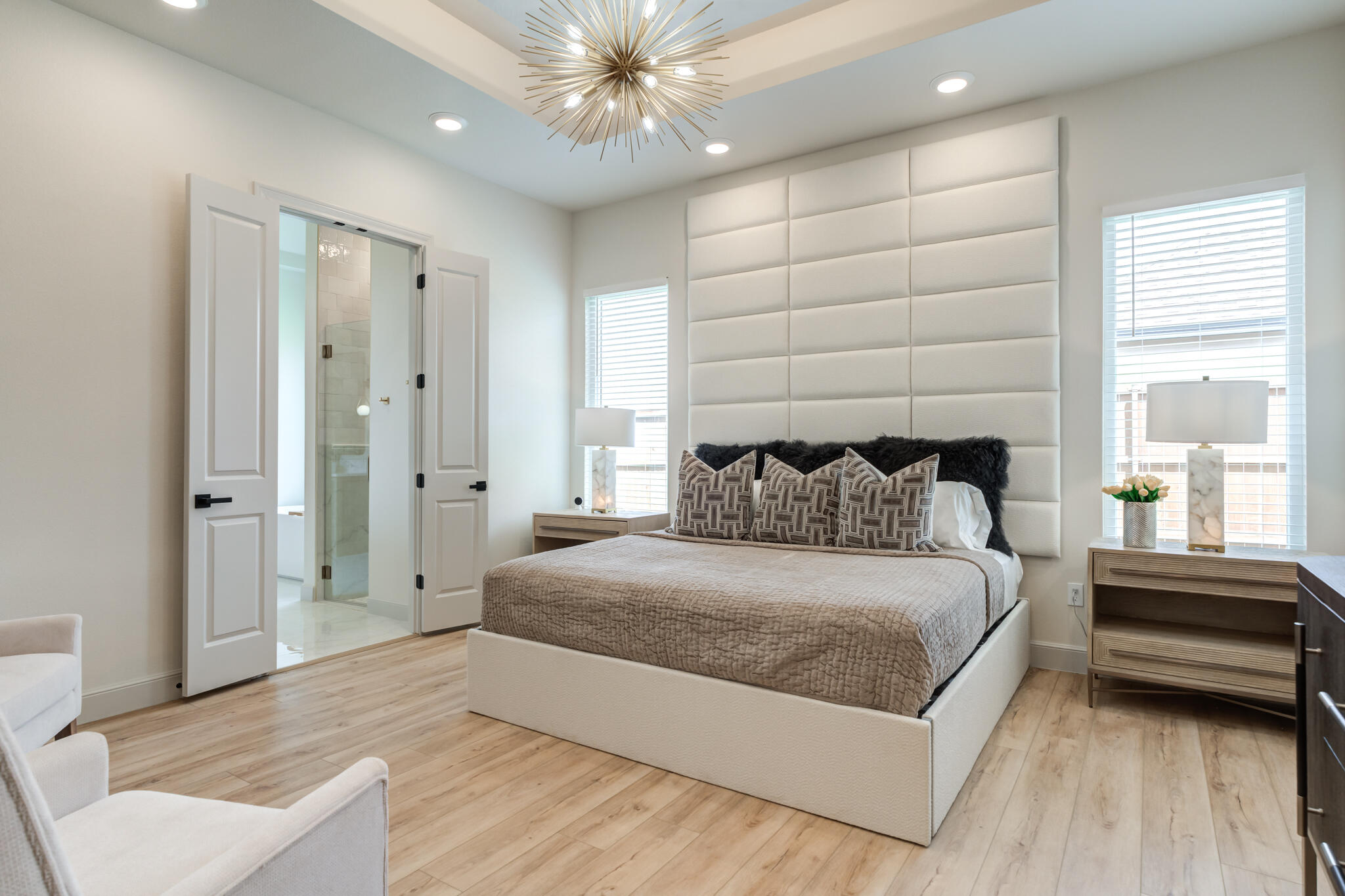 609 North 15th Street Wolfforth, TX 79382 - Photo 32 of 76 a spacious bedroom with a bed and a chandelier