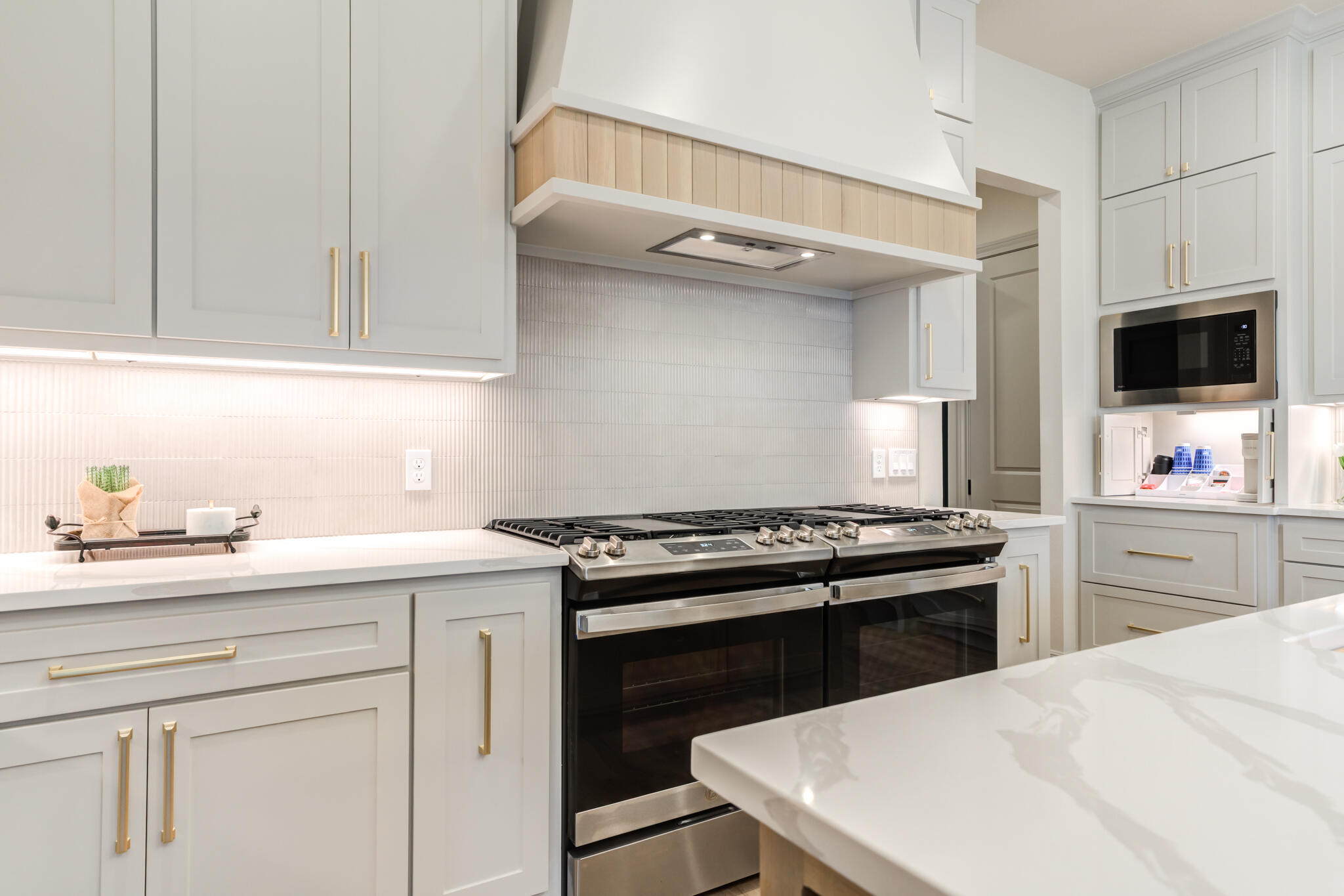 609 North 15th Street Wolfforth, TX 79382 - Photo 58 of 76 a kitchen with a stove and a white cabinets