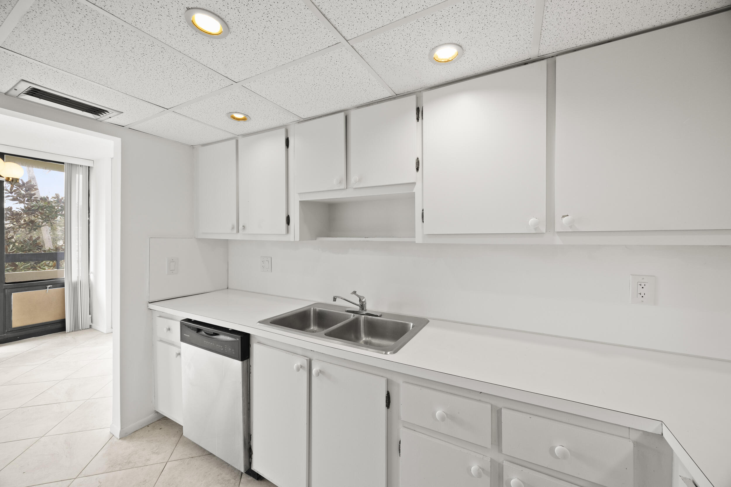 Undisclosed Address Boca Raton, FL 33432 - Photo 14 of 27 a kitchen with white cabinets and white appliances