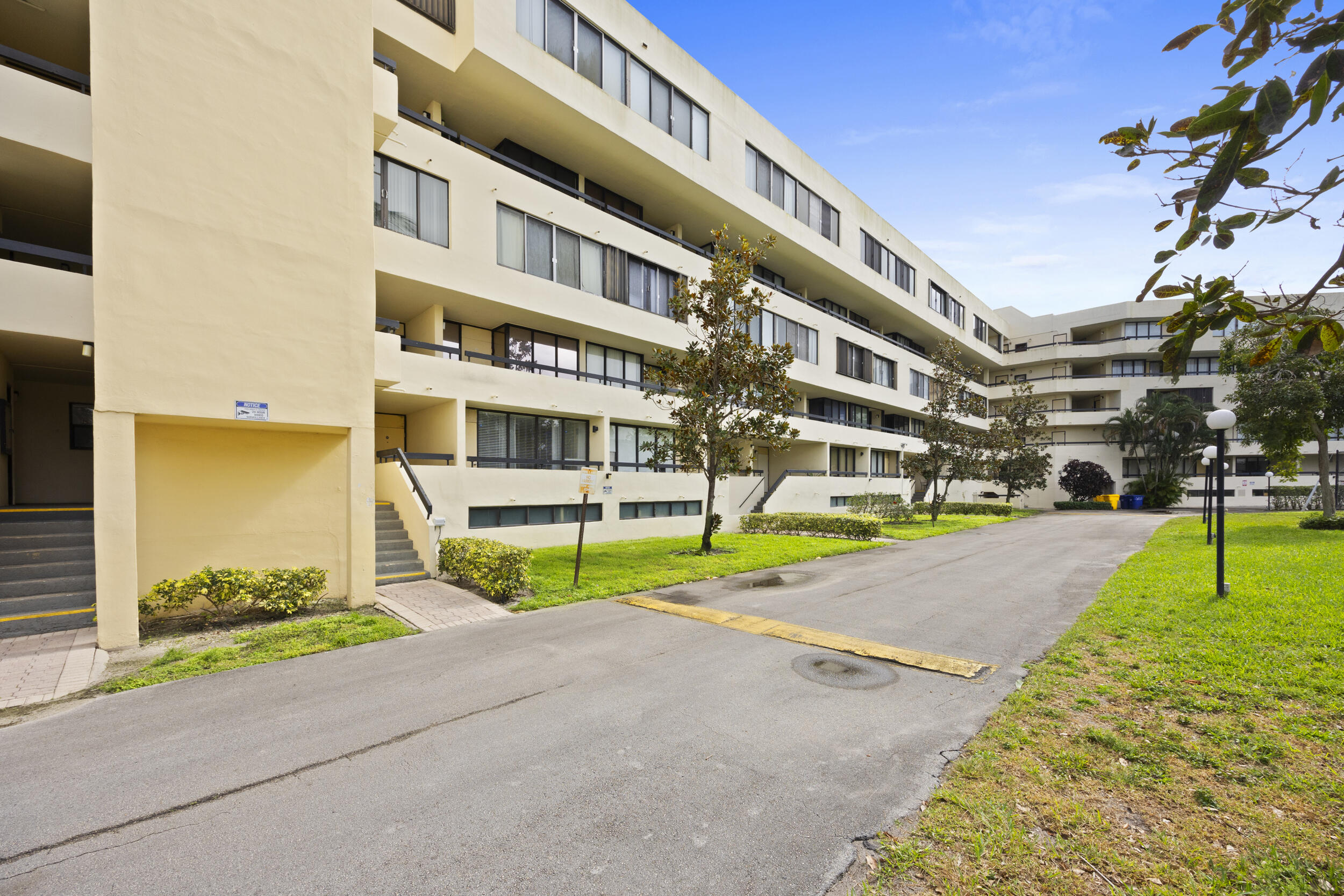 Undisclosed Address Boca Raton, FL 33432 - Photo 2 of 27 a multi story building with trees in front of it