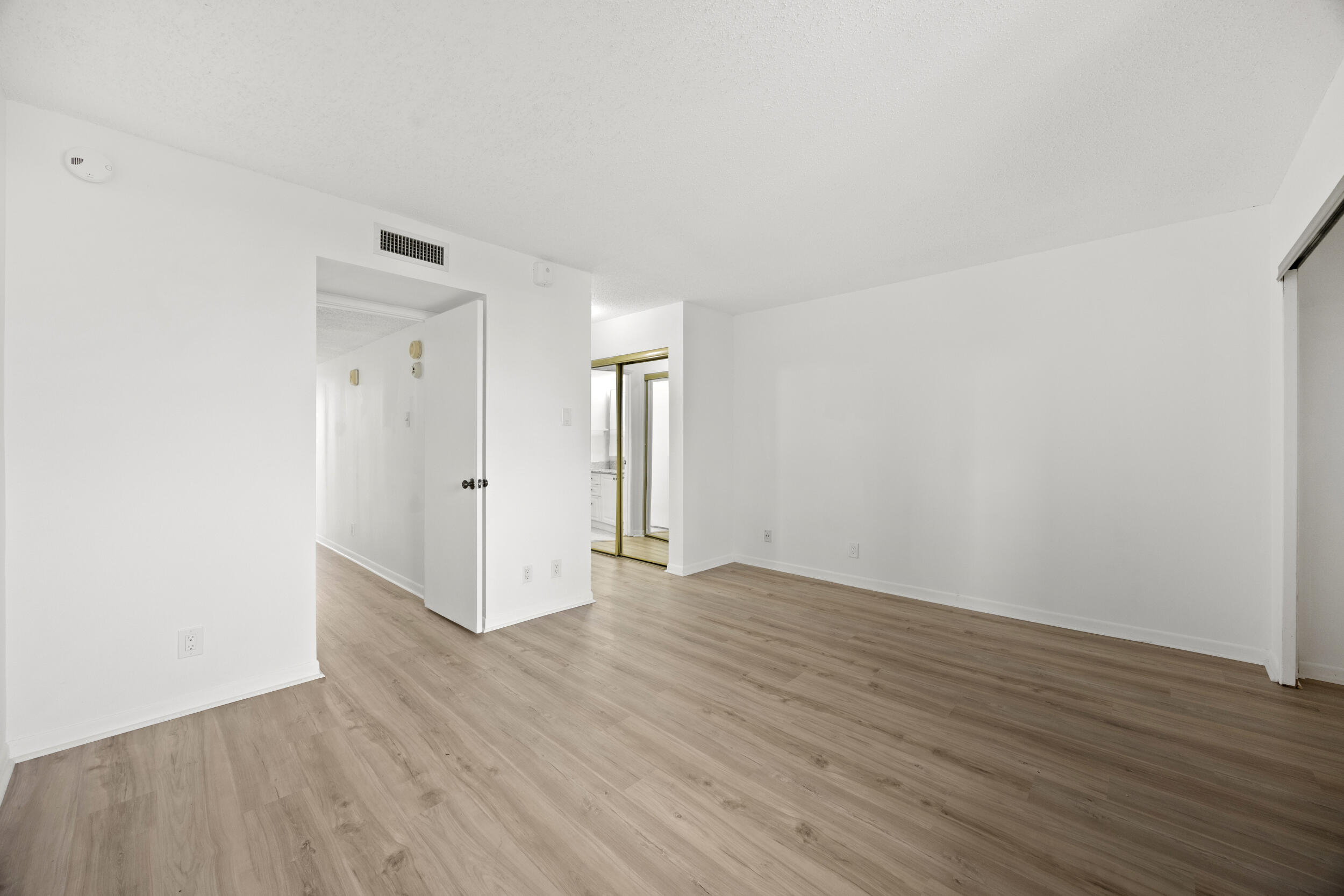 Undisclosed Address Boca Raton, FL 33432 - Photo 25 of 27 a view of an empty room with wooden floor