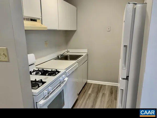 a kitchen with a stove and a refrigerator