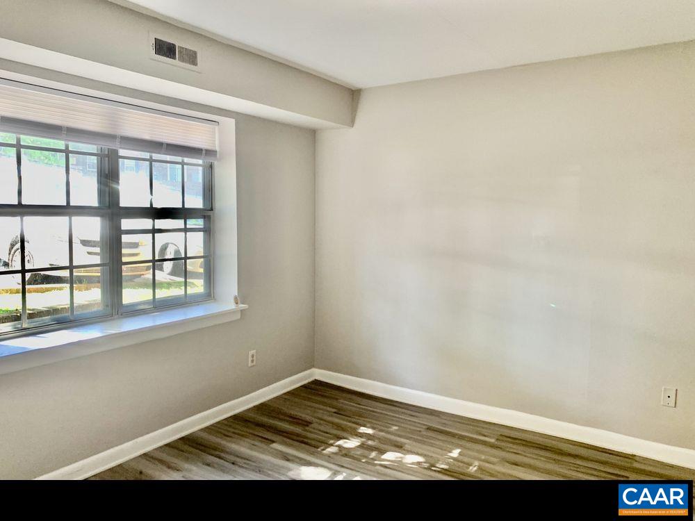 545 Burgoyne Road, Unit 5 Charlottesville, VA 22901 - Photo 5 of 9 a view of empty room with wooden floor