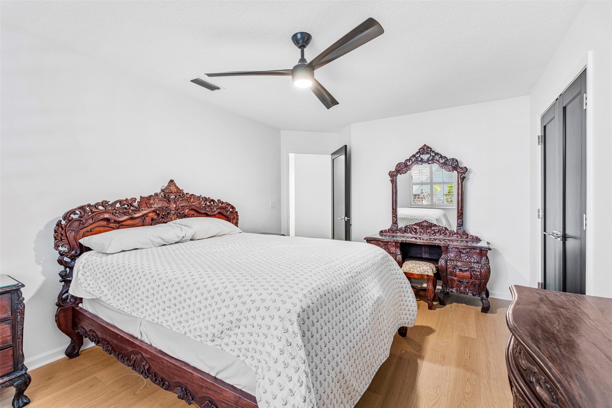 4708 Rigging Drive Fernandina Beach, FL 32034 - Photo 21 of 32 a bedroom with a bed a dresser and potted plants